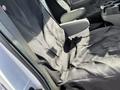 A black seat cover is draped over the driver and passenger seats of a 2008 Ford Econoline