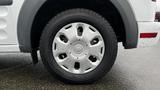 A close-up view of a silver wheel on a 2012 Ford Transit with a distinctive five-spoke design and a Continental tire