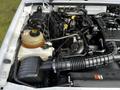 Engine compartment of a 2010 Ford Ranger showing various components including the air intake hose reservoir and engine parts