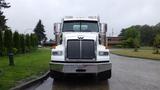 A 2019 Western Star Trucks 4900 SA with a prominent chrome grille and large side mirrors positioned directly facing the viewer