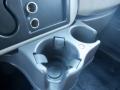 A gray plastic cup holder with two compartments located in the front interior of a 2014 International Durastar vehicle