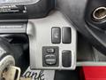 Control panel of a 2018 Hino 195 featuring buttons for heated mirrors and mirror adjustment with a vehicle key ignition visible in the foreground
