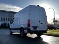 A white 2021 Mercedes-Benz Sprinter van with a high roof and large cargo area seen from the rear angle