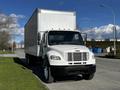 A 2016 Freightliner M2 106 box truck with a white exterior parked on a roadside showcasing its large cargo area and distinctive grille design