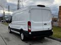 A white 2020 Ford Transit van viewed from the rear showing its sleek design and rear doors