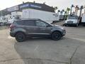 A gray 2019 Ford Escape parked with black wheels and a sleek design shown from the side