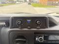 Control panel of a 2010 Ford Econoline featuring knobs for temperature and direction with a digital display for heat settings