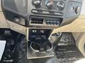 Interior view of a 2008 Ford F-450 SD dashboard featuring climate control knobs and a center console with cup holders and storage compartments