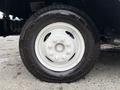 A close-up view of a white wheel and tire from a 2018 Ford Econoline featuring five lug nuts and a deep tread pattern on the tire