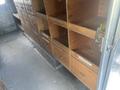 Interior of a 2007 Morgan Olson Workhorse W42 with several wooden storage compartments and drawers visible on one side