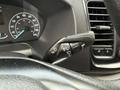 Close-up of the control stalk on the steering column of a 2023 Ford Transit featuring various buttons for wipers and turn signals