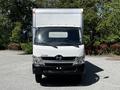 Front view of a 2018 Hino 195 box truck with a white body and silver accents parked in a lot