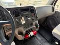 Interior dashboard of a 2015 Freightliner M2 106 featuring controls gauges and a fire extinguisher mounted beneath the dashboard