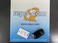 A black key fob for a 2015 Kia Sorento attached to a keychain with a tag showing information about the vehicle