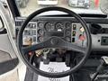 Overview of the dashboard of a 1998 Freightliner FL80 showing gauges controls and a steering wheel