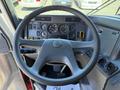 View of the steering wheel and dashboard of a 2004 American LaFrance Eagle featuring gauges controls and buttons