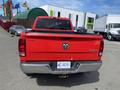 A 2012 RAM 2500 truck in red with a visible logo on the tailgate and a license plate with the number WE-8291