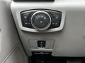 Close-up of the control panel in a Ford F-350 SD featuring knobs and buttons for lights and settings