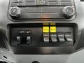 Dashboard controls of a 2011 Ford F-550 featuring switches for auxiliary functions and a Power Take-Off system