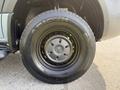 A close-up of a 2019 Mercedes-Benz Sprinter tire showcasing a black wheel with a silver hubcap and a treaded tire design