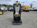 2024 AGT Industrial Yellow H13R Mini Excavator facing forward with a protective cover on the digging arm and metal tracks visible at the base