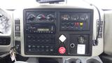 Dashboard of a 2012 International 7400 featuring gauges switches a radio and various controls for vehicle functions