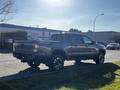 2021 Toyota Tacoma in gray color with a modern design featuring a double cab and sporty wheels parked on the street