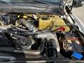 Close-up view of the engine compartment of a 2018 Ford F-550 showcasing various components including hoses, a battery, and a coolant reservoir