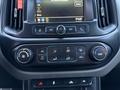 The dashboard of a 2018 Chevrolet Colorado showing climate control buttons and a touchscreen display with vehicle settings