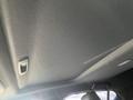 Interior view of a 2023 Mazda MAZDA3 showing the ceiling with light gray fabric and two grab handles