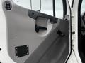 The interior door panel of a 2018 Freightliner M2 106 featuring a handle a knob and a black panel with labels