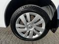 Close-up of a silver alloy wheel from a 2017 Nissan NV200 featuring five spokes and mounted on a black tire with visible tread pattern