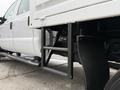 A 2013 Ford F-550 truck showing a side view of a metal ladder leading up to the vehicle's cargo area