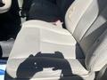 The image shows the front driver's seat of a 2013 Ford Expedition featuring gray fabric upholstery with a small tear on the side