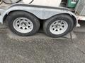 A 2011 Hightliner Aquacide Hot Water Weed Control Dual Flat Deck Trailer with two large silver wheel rims and black tires