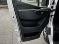 A 2020 Mercedes-Benz Sprinter door panel featuring a sleek black design with a handle and storage compartment
