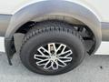 A close-up view of a 2010 Mercedes-Benz Sprinter wheel featuring an alloy rim and a rugged tire tread
