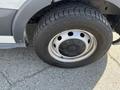 A close-up of a 2016 Ford Transit tire featuring a silver wheel and a textured black tire tread