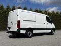 A white 2020 Mercedes-Benz Sprinter van with a streamlined design and standard wheels parked at an angle showing its side and rear features