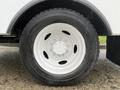 Close-up of a white wheel with a black tire marked with "Goodyear" and featuring six metal bolts on the rim