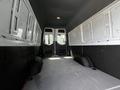 Interior view of a 2019 Mercedes-Benz Sprinter cargo van showing empty space with grey flooring and white paneling