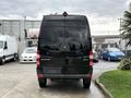A black 2017 Mercedes-Benz Sprinter van viewed from the rear with a smooth finish and the brand logo displayed prominently