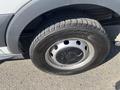 A close-up view of the wheel of a 2016 Ford Transit featuring a silver rim and a black tire with visible tread patterns