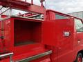 A red 2001 Toyota Dyna truck with an open storage compartment showcasing an empty interior