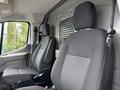 Interior view of a 2023 Ford Transit showing two black cloth front seats without any occupants
