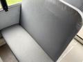 A gray bench seat in a 2013 International 3000 with textured upholstery and a simple design