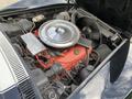 Close-up of a 1972 Chevrolet Corvette engine showcasing the large air cleaner and various engine components in vibrant red and black colors