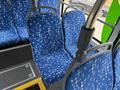 Interior view of a 2018 Grande West Vicinity bus featuring blue patterned seats with armrests arranged in a row