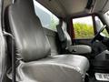 The interior of a 2011 International 4400 truck featuring black leather seats and a driver's side dashboard with controls