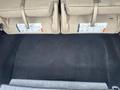 A 2016 Ford Explorer with folded rear seats revealing a spacious, clean cargo area with black carpeting and storage instructions visible on the seatbacks